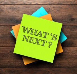 What's Next is written on a stack of post it notes.