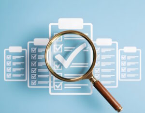 Magnifying glass over an audit checklist