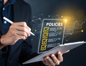 Hand ticking a digital checklist of policies.