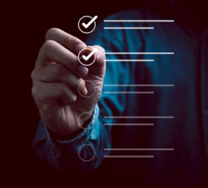 Businessman using pen to tick audit options in a digital checklist