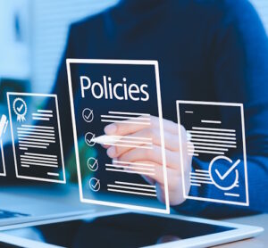 Transparent digital screen with policies written on and a man in the background