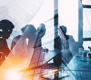 Business people sitting in a sunlit office around a corporate table